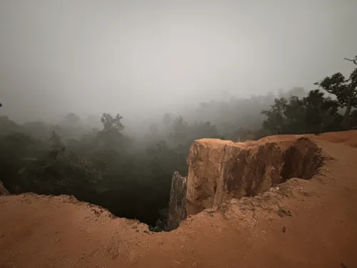 Misty red-clay canyon near Pai