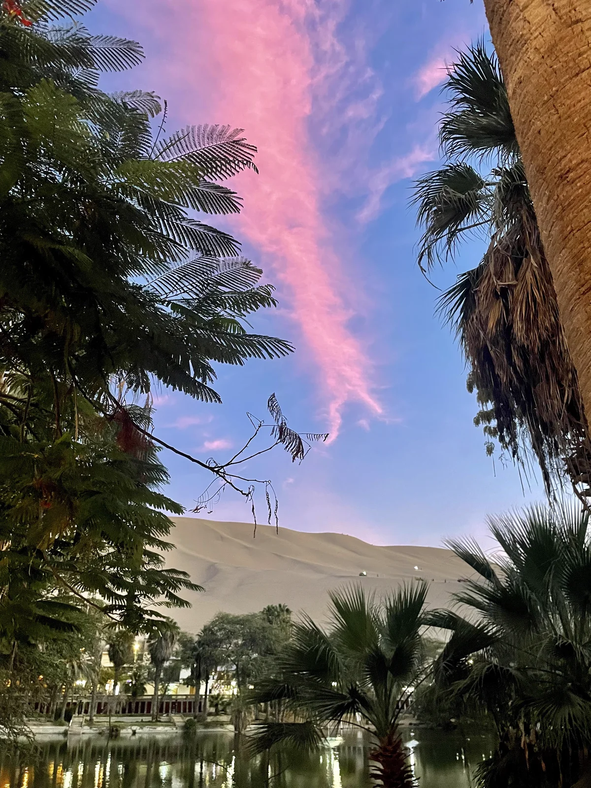 Pink sunset over Huacachina oasis